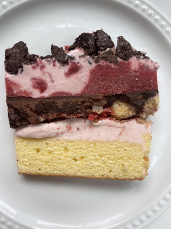 Thick slice of Strawberry Crunch Ice Cream Cake with Chocolate Crunchies on a plate