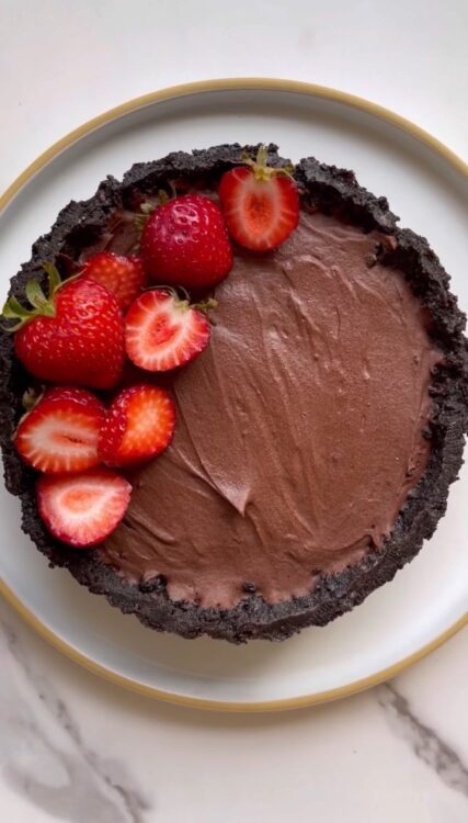 Chocolate Strawberry No Bake Tart on a plate topped with strawberries