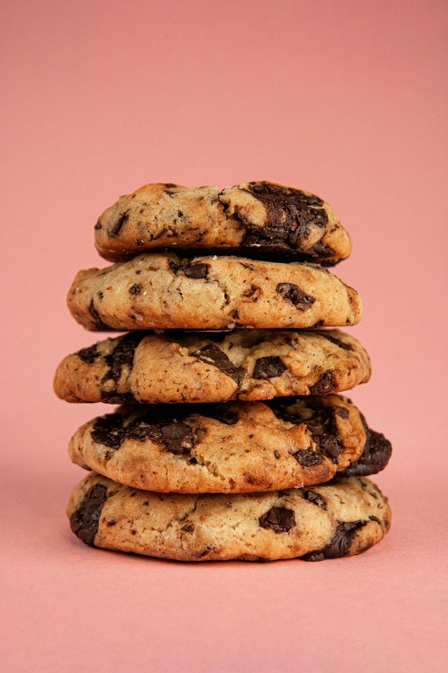 photo of a stack of chocolate chip cookies against a pink background on Lily P Crumbs' ranking of the best chocolate chip cookie recipes