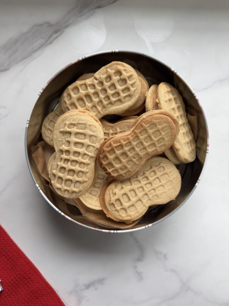 Homemade Nutter Butters in a cookie tin