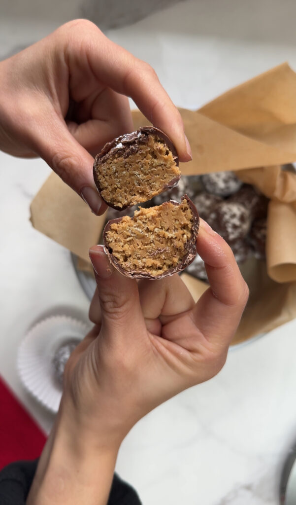 Puppy chow truffles cut open, puppy chow truffles inside with hands holding them