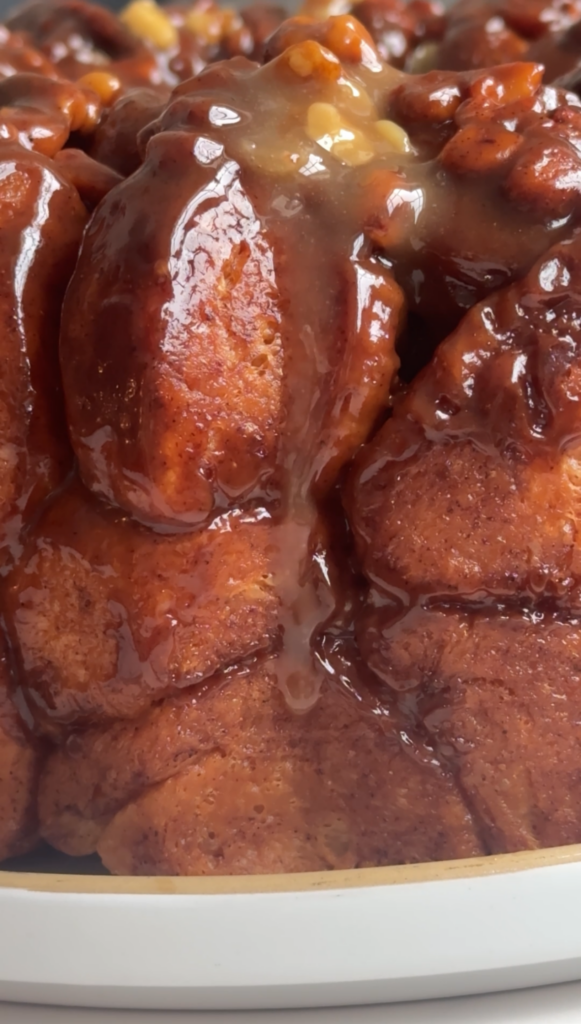 Close up shot of monkey bread with caramel walnut dripping