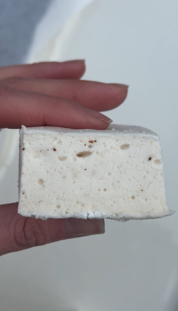 Creative s'more idea, brown butter marshmallows on plate across from bon fire. On the plate with graham crackers, chocolate bars and ghiradelli caramel chocolate sqaures