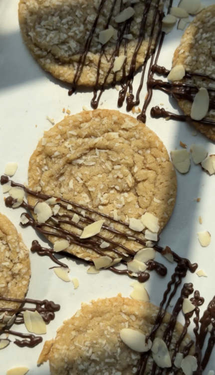 Coconut Cookies on sheet with chocolate drizzle