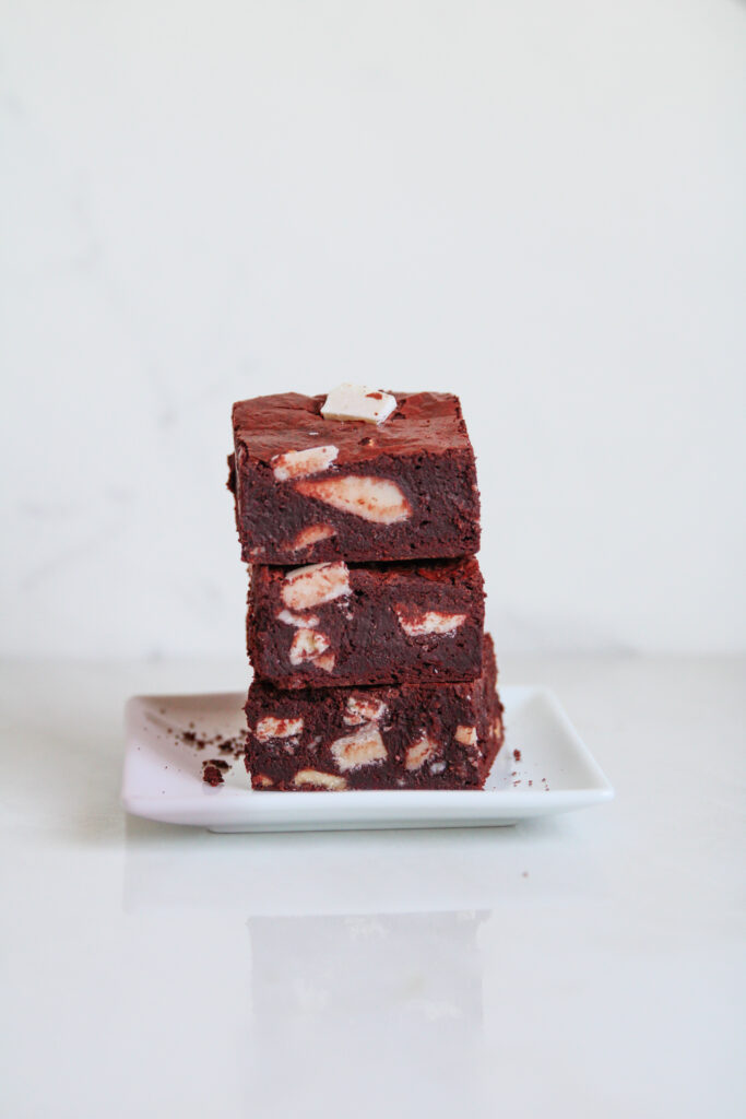 Red velvet brownies stacked on a plate